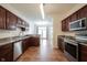 Kitchen featuring stainless steel appliances, granite countertops, and a view into the dining area at 2332 Brightwell Pl, Indianapolis, IN 46260