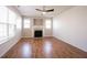 Cozy living room with fireplace, ceiling fan, and wood floors at 2332 Brightwell Pl, Indianapolis, IN 46260