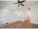 Open loft area includes wood floors, recessed lighting, and staircase access, great as a second living space at 2332 Brightwell Pl, Indianapolis, IN 46260