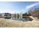 Scenic view of a peaceful pond surrounded by lush greenery and neighboring townhomes, creating a serene atmosphere at 2332 Brightwell Pl, Indianapolis, IN 46260