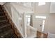 Bright foyer showcasing the white staircase with wood and carpet steps at 2332 Brightwell Pl, Indianapolis, IN 46260