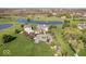 Aerial view of a large, beautiful home on a well-manicured lot with a pond at 2766 S Honey Creek S Rd, Greenwood, IN 46143
