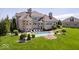 Gorgeous backyard with a sparkling pool, patio seating, and manicured lawn for relaxing and entertaining at 2766 S Honey Creek S Rd, Greenwood, IN 46143