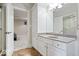 Modern bathroom featuring white cabinets, stone countertops, and tiled flooring at 2766 S Honey Creek S Rd, Greenwood, IN 46143