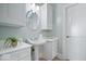 Charming bathroom with pedestal sink, decorative mirror, and ample storage cabinets at 2766 S Honey Creek S Rd, Greenwood, IN 46143