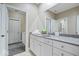 Well-lit bathroom featuring stone countertops, white cabinets, and a large mirror at 2766 S Honey Creek S Rd, Greenwood, IN 46143