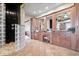 Beautiful primary bath featuring a tiled floor, double sink vanity, and glass block shower at 2766 S Honey Creek S Rd, Greenwood, IN 46143
