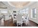 Open dining area featuring a chandelier, fireplace and connecting to a gourmet kitchen with ample seating at 2766 S Honey Creek S Rd, Greenwood, IN 46143