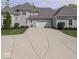 Wide driveway leads to a two-car garage, complemented by manicured landscaping and a neutral exterior at 2766 S Honey Creek S Rd, Greenwood, IN 46143