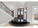 Elegant foyer with a winding staircase, stylish tile flooring, and a grand double-door entrance at 2766 S Honey Creek S Rd, Greenwood, IN 46143