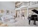 Spacious foyer boasts soaring ceilings, ornate staircase, and grand piano, creating a luxurious entrance at 2766 S Honey Creek S Rd, Greenwood, IN 46143