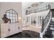 Luxurious foyer with a grand staircase, soaring ceilings, and elegant decor creating a stunning first impression at 2766 S Honey Creek S Rd, Greenwood, IN 46143