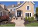 Inviting front entrance with elegant columns, arched doorway, and professionally landscaped garden beds at 2766 S Honey Creek S Rd, Greenwood, IN 46143