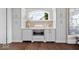 Custom built-in kitchen nook with white cabinets and a window overlooking the yard at 2766 S Honey Creek S Rd, Greenwood, IN 46143