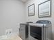 This laundry room features a side-by-side washer and dryer set, plus artwork at 2766 S Honey Creek S Rd, Greenwood, IN 46143