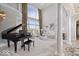 Elegant living room featuring a grand piano, soaring windows, and sophisticated decor at 2766 S Honey Creek S Rd, Greenwood, IN 46143