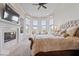 Comfortable main bedroom suite featuring a fireplace, sitting area and picturesque windows with a view at 2766 S Honey Creek S Rd, Greenwood, IN 46143