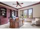 This home office boasts built-in bookshelves and a large desk by a bright window at 2766 S Honey Creek S Rd, Greenwood, IN 46143
