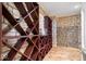 Wine storage area with wooden rack and stone walls at 2766 S Honey Creek S Rd, Greenwood, IN 46143