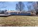 Exterior view of a cozy house with a well-sized backyard and a wooden deck at 320 E 86Th St, Indianapolis, IN 46240
