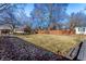 Spacious backyard with a charming wooden fence, mature trees and a small playset at 320 E 86Th St, Indianapolis, IN 46240