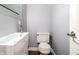 Powder room featuring modern sink and toilet fixtures, clean lines, and minimalist design at 320 E 86Th St, Indianapolis, IN 46240