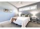 Cozy bedroom with a large window, neutral carpeting, and light blue walls, creating a serene atmosphere at 320 E 86Th St, Indianapolis, IN 46240