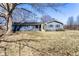 Charming blue single-story home with a sunny yellow front door and a well-manicured front yard at 320 E 86Th St, Indianapolis, IN 46240