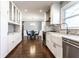 Bright kitchen with stainless steel appliances, white cabinets, subway tile backsplash, and a view of the dining area at 320 E 86Th St, Indianapolis, IN 46240