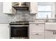 Well-appointed kitchen featuring modern appliances, stylish tile backsplash, and ample counter space at 320 E 86Th St, Indianapolis, IN 46240