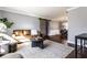Spacious living room with hardwood floors, a cozy sofa, and an open view to the dining area at 320 E 86Th St, Indianapolis, IN 46240