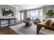 Inviting living room with large windows, comfortable seating, and stylish decor for relaxing at 320 E 86Th St, Indianapolis, IN 46240