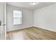 A clean bedroom with a large window and attractive wood-look flooring at 3224 N Capitol Nw Ave, Indianapolis, IN 46208