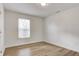 A clean bedroom with a large window and attractive wood-look flooring at 3224 N Capitol Nw Ave, Indianapolis, IN 46208