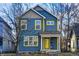 Charming two-story home featuring blue siding, bright yellow trim, and inviting front porch at 3224 N Capitol Nw Ave, Indianapolis, IN 46208