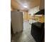 Kitchen featuring a black stove, a white refrigerator, and patterned flooring at 3614 N Whittier Pl, Indianapolis, IN 46218