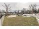 Aerial view of a covered pool surrounded by a fenced yard, a storage shed, and the main house at 37 N Main St, Indianapolis, IN 46227