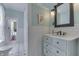 Charming bathroom with elegant vanity, subway tile, and a view into the bedroom at 37 N Main St, Indianapolis, IN 46227