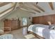 Inviting bedroom featuring a wood beam ceiling, hardwood floors and warm sunlight at 37 N Main St, Indianapolis, IN 46227