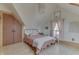Charming bedroom featuring hardwood floors, pink bedding and a modern light fixture at 37 N Main St, Indianapolis, IN 46227