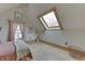 Bright bedroom featuring a skylight, hardwood floors and pink curtains at 37 N Main St, Indianapolis, IN 46227