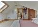 Bright bedroom features a skylight, wood floors, and a doorway leading to an upper level landing at 37 N Main St, Indianapolis, IN 46227