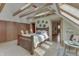 Relaxing bedroom featuring a skylight, a wood beam ceiling and hardwood floors at 37 N Main St, Indianapolis, IN 46227