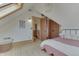 Bright bedroom features a skylight, wood floors, and a doorway leading to an upper level landing at 37 N Main St, Indianapolis, IN 46227