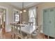 Charming dining area featuring a classic white table, wooden floors, and a unique vintage blue locker at 37 N Main St, Indianapolis, IN 46227