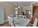 An inviting dining room featuring a rustic wood table, floors, and access to the kitchen with modern appliances at 37 N Main St, Indianapolis, IN 46227