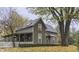 Charming two-story home with mature trees, covered porch, and white picket fence at 37 N Main St, Indianapolis, IN 46227