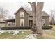 Beautiful two-story home featuring detailed trim and mature tree at 37 N Main St, Indianapolis, IN 46227