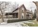 Charming two-story home with a covered porch, white picket fence, and manicured landscaping at 37 N Main St, Indianapolis, IN 46227