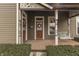 Inviting front porch with swing, decorative columns, and well-maintained landscaping at 37 N Main St, Indianapolis, IN 46227